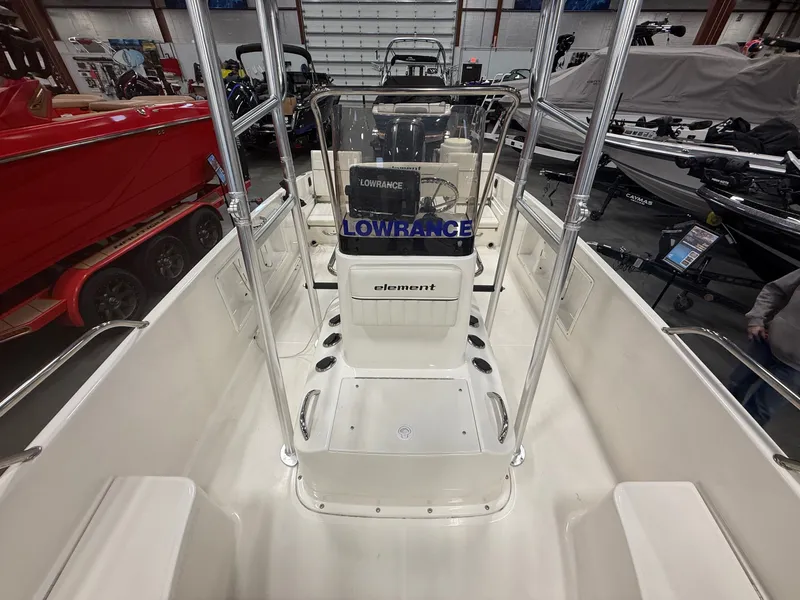 Slide: The Image of Interior view of a 2018 Bayliner Element F21 boat in showroom. - 19