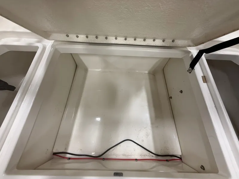 Slide: The Image of Open storage compartment in 2018 Bayliner Element F21 boat. - 9