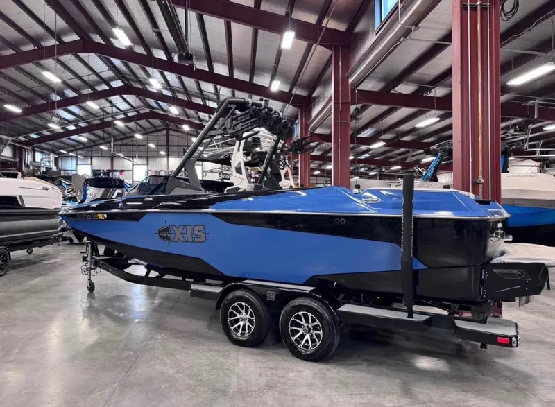 The Image of 2021 Axis A24 boat in blue color inside a warehouse. - 1