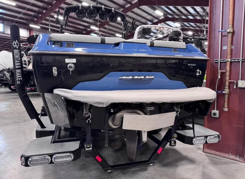 Slide: The Image of Rear view of a blue 2021 Axis A24 boat in a warehouse. - 3