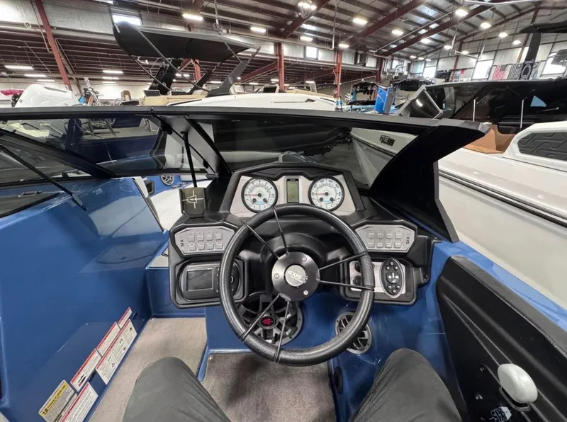 Slide: The Image of Interior view of 2021 Axis A24 boat cockpit with steering wheel and gauges. - 4