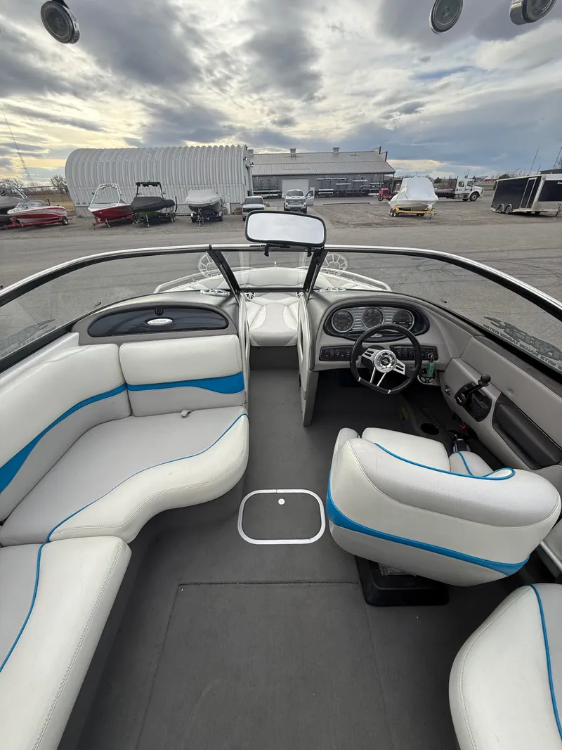 The Image of Interior of a 2005 Malibu Wakesetter VLX boat, gray and blue upholstery. - 5