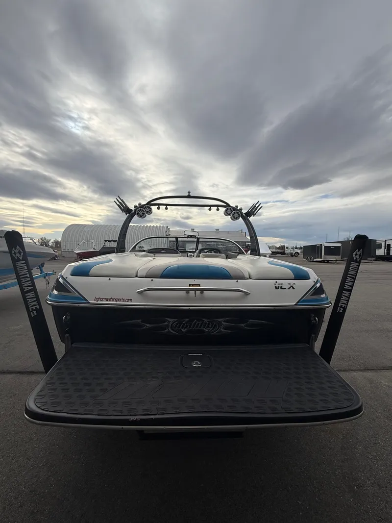Slide: The Image of 2005 Malibu Wakesetter VLX boat parked under cloudy sky. - 9