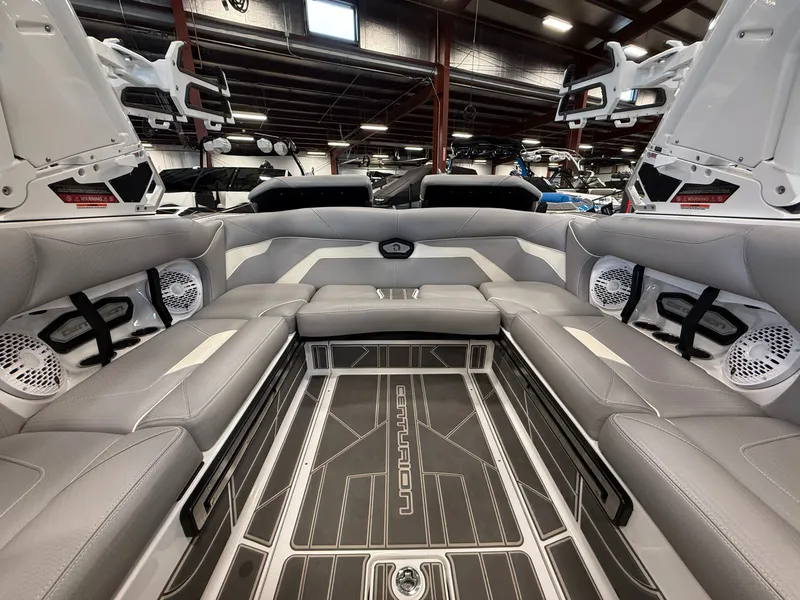 Slide: The Image of Interior of 2023 Centurion Ri230 boat with gray seating and speakers. - 12