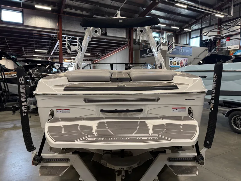 Slide: The Image of 2023 Centurion Ri230 boat in showroom, rear view. - 4