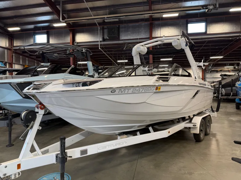 Slide: The Image of 2023 Centurion Ri230 boat on trailer in warehouse. - 7