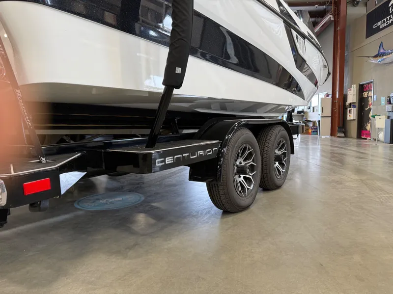Slide: The Image of 2024 Centurion Fi23 boat on trailer in a showroom. - 18