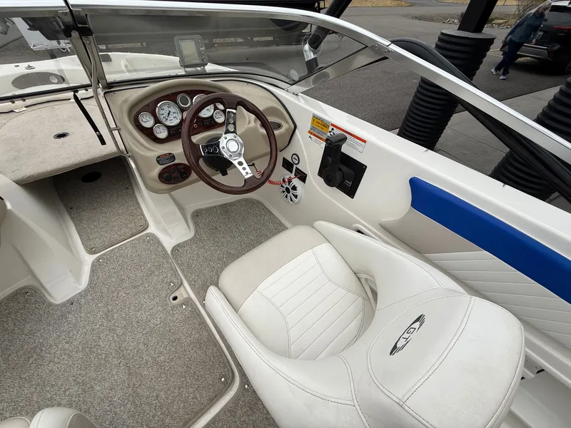 Slide: The Image of Interior of a 2008 Glastron GT 205 boat with steering console. - 10