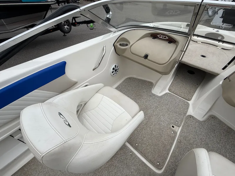 Slide: The Image of Interior of a 2008 Glastron GT 205 boat with white seating. - 11