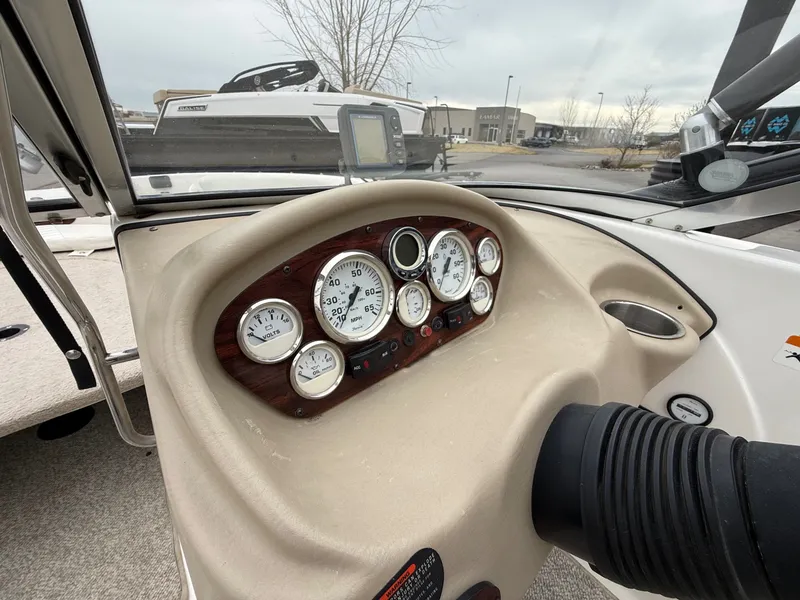 Slide: The Image of Dashboard of a 2008 Glastron GT 205 boat with gauges. - 13