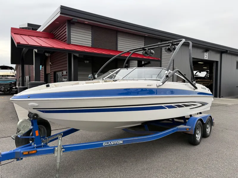 Slide: The Image of 2008 Glastron GT 205 boat on trailer in front of building. - 5