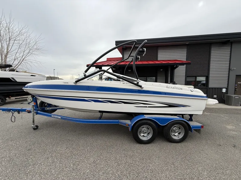 Slide: The Image of 2008 Glastron GT 205 boat on trailer in front of building. - 6