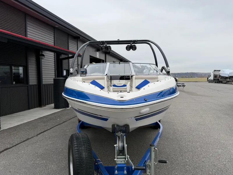 Slide: The Image of 2008 Glastron GT 205 boat on trailer in front of building. - 7