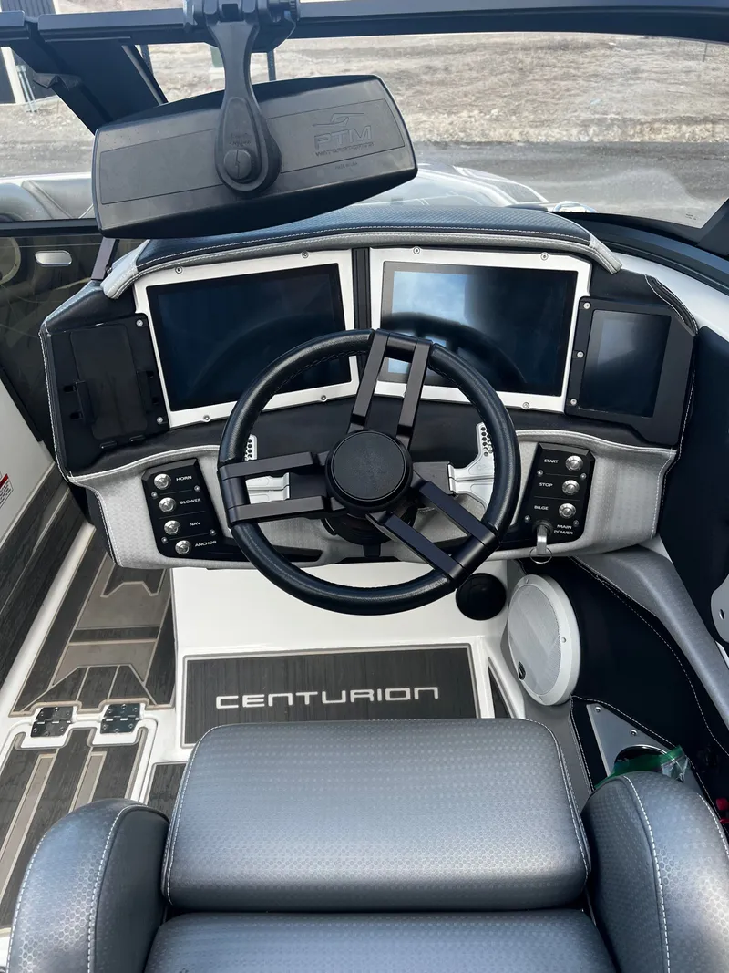 Slide: The Image of 2023 Centurion Ri230 boat cockpit with modern steering and screens. - 13