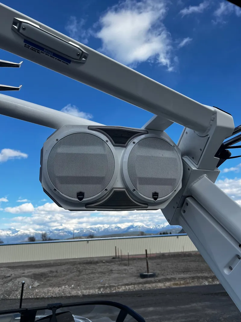 Slide: The Image of Speakers on a 2023 Centurion Ri230 boat with mountain backdrop. - 19