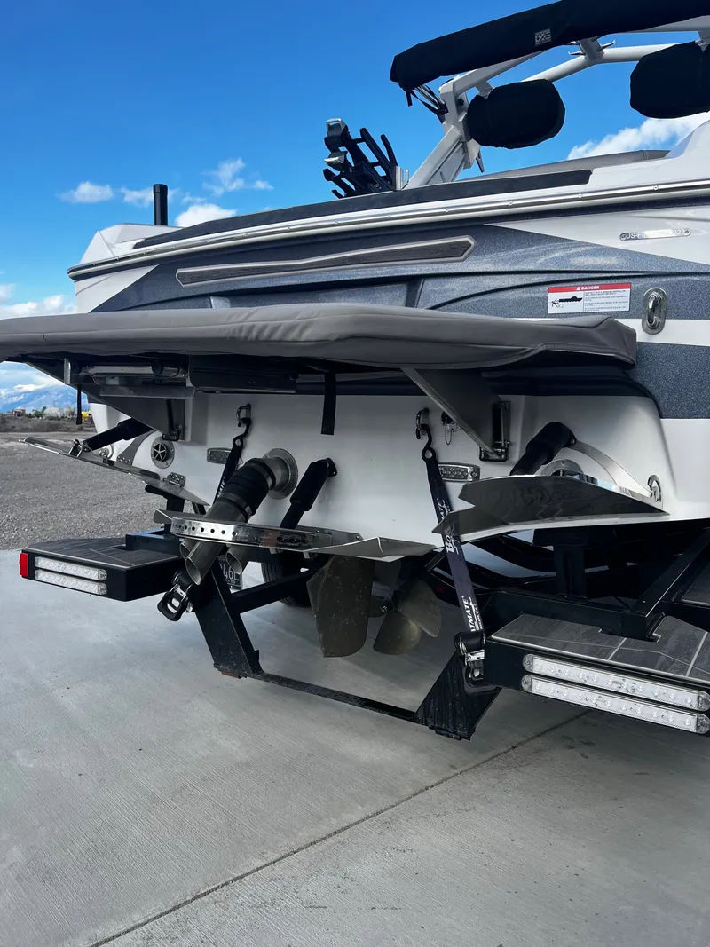 Slide: The Image of Rear view of a 2023 Centurion Ri230 boat on concrete. - 9