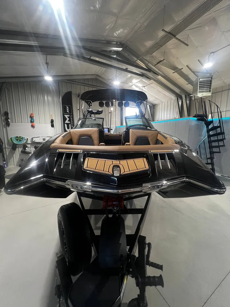 Slide: The Image of 2024 MasterCraft X STAR S boat in a warehouse. - 13