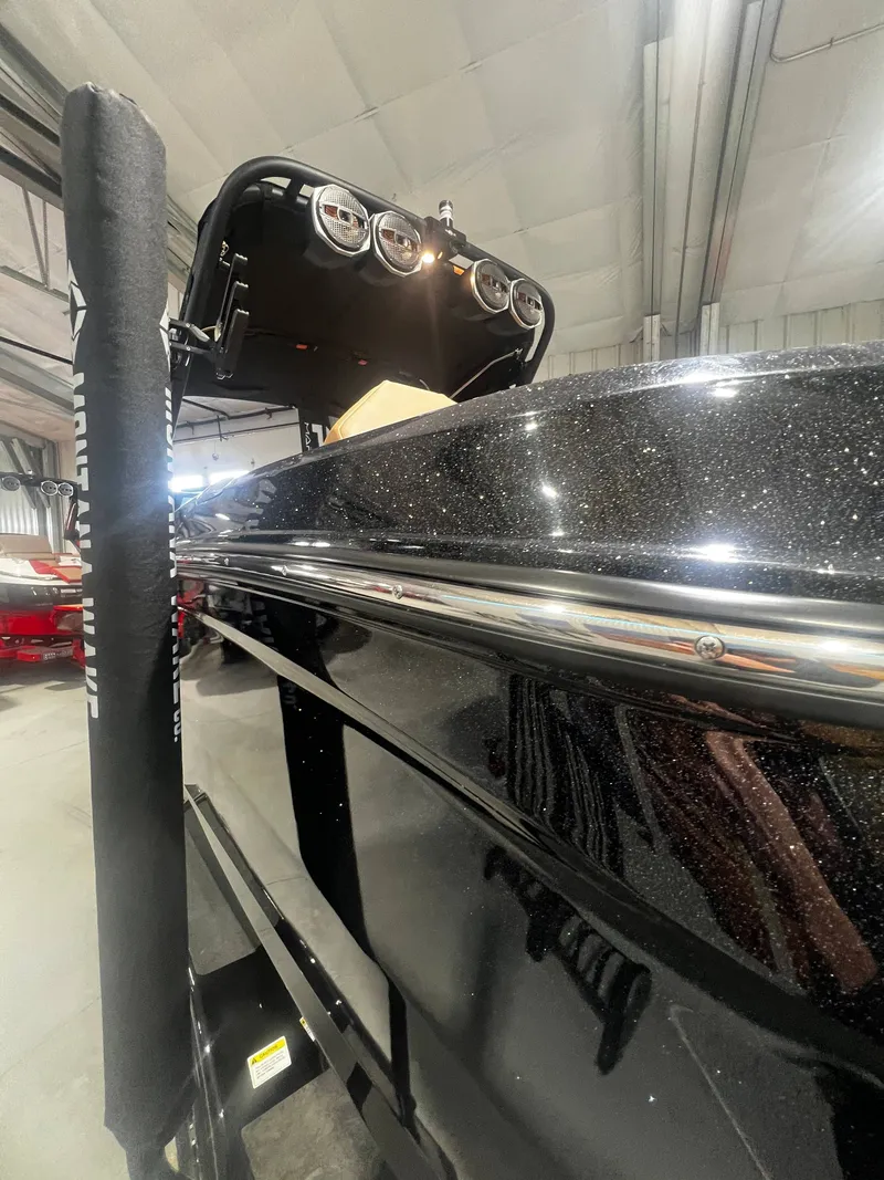 Slide: The Image of 2024 MasterCraft X STAR S boat in a warehouse. - 16