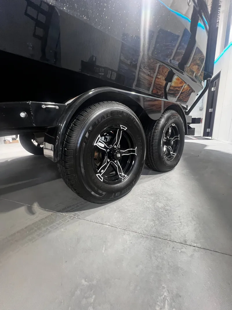Slide: The Image of Close-up of 2024 MasterCraft X STAR S trailer wheels. - 21