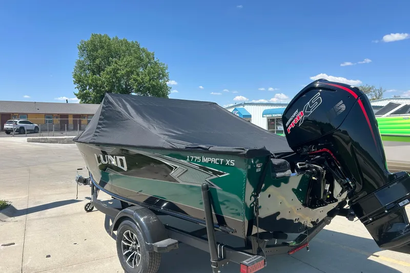 Slide: The Image of 2026 Lund 1775 Impact XS Sport boat with cover and powerful outboard motor. - 12