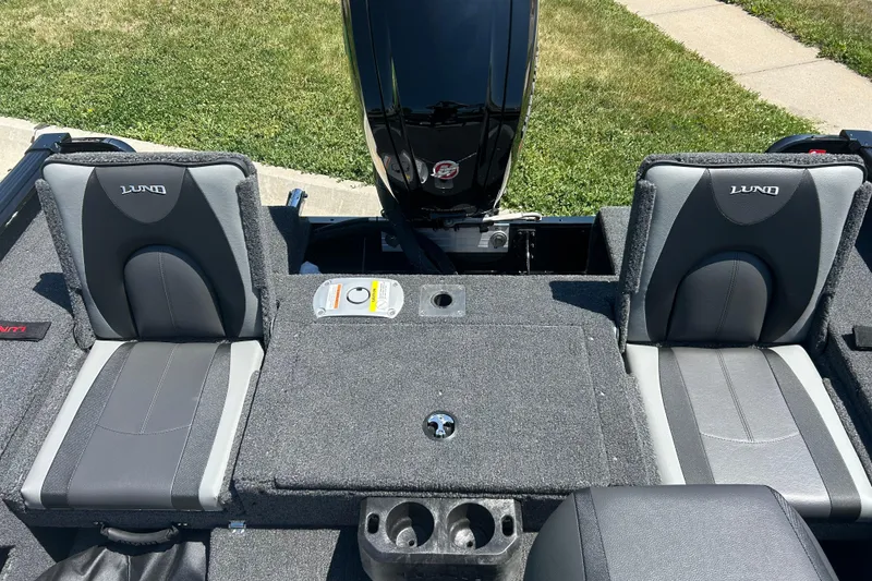 Slide: The Image of 2026 Lund 1775 Impact XS Sport boat interior with gray seating and motor. - 21