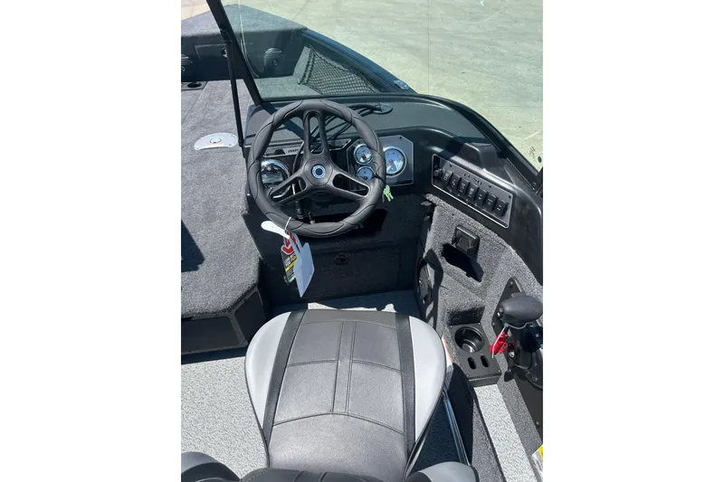 Slide: The Image of 2026 Lund 1775 Impact XS Sport boat interior with steering wheel and dashboard controls. - 23