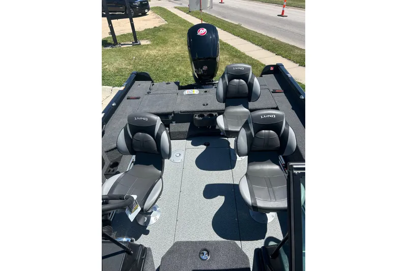 Slide: The Image of 2026 Lund 1775 Impact XS Sport boat interior with four seats and motor. - 24