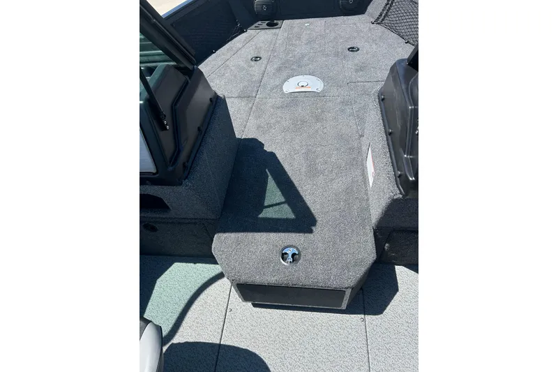 Slide: The Image of Interior view of 2026 Lund 1775 Impact XS Sport boat, featuring carpeted deck and storage compartments. - 26