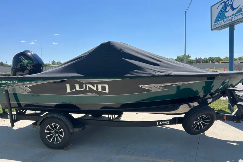 Slide: The Image of Manufacturer Provided Image: 2025 Lund 1775 Impact XS Sport boat deck with fishing gear on a lake. - 31