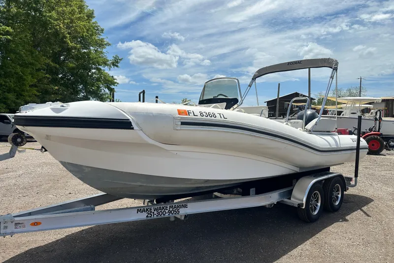 The Image of 2023 Zodiac N-ZO 680 boat on trailer, parked outdoors under a clear sky. - 0