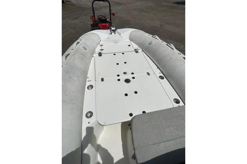 Slide: The Image of 2023 Zodiac N-ZO 680 boat deck with seating and storage compartments. - 11