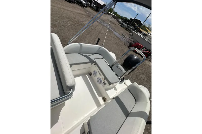 Slide: The Image of 2023 Zodiac N-ZO 680 boat interior with seating and console, parked outdoors. - 16