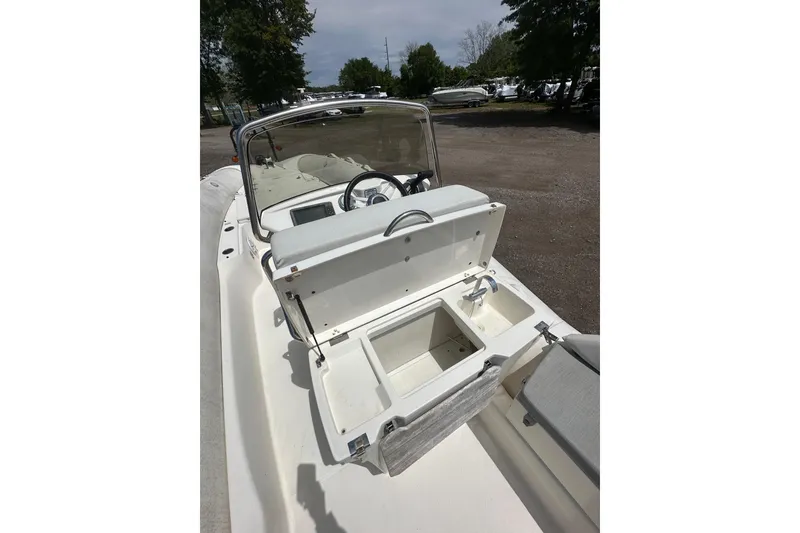 Slide: The Image of 2023 Zodiac N-ZO 680 boat interior with open storage compartment and steering wheel. - 18