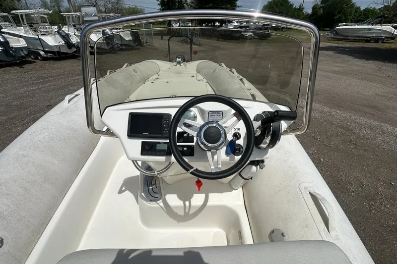 Slide: The Image of 2023 Zodiac N-ZO 680 boat dashboard with steering wheel and controls. - 21