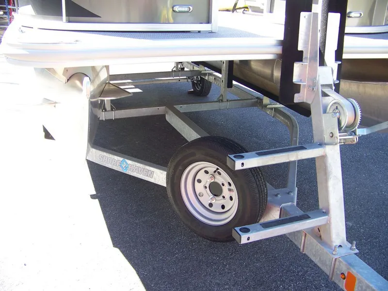 Slide: The Image of 2024 Starcraft LX 20 R boat on trailer, close-up view. - 12