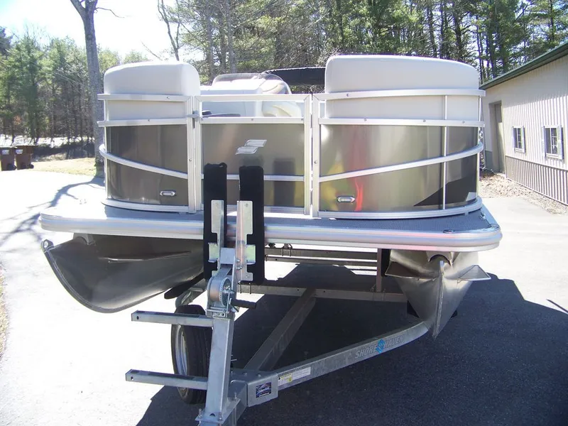 Slide: The Image of 2024 Starcraft LX 20 R pontoon boat on trailer outdoors. - 9