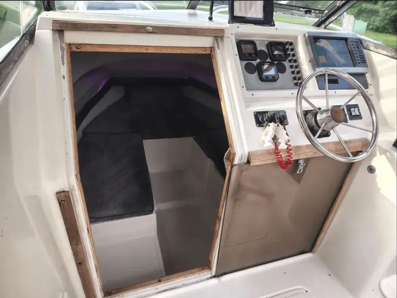 Slide: The Image of Interior of a 1990 Pursuit 2350 boat with steering console. - 10