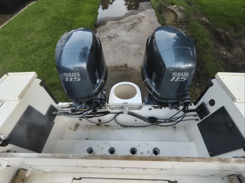 Slide: The Image of Two Yamaha 115 outboard motors on a 1990 Pursuit 2350 boat. - 14