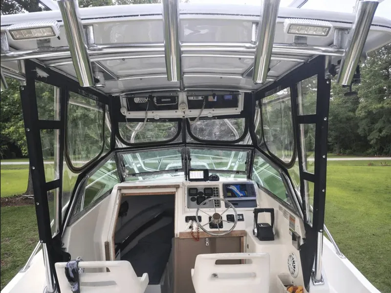 Slide: The Image of Interior view of a 1990 Pursuit 2350 boat with helm console. - 3