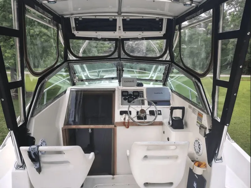 Slide: The Image of Interior view of a 1990 Pursuit 2350 boat with helm console. - 4
