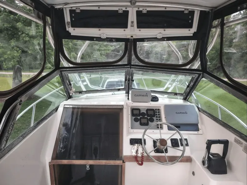 Slide: The Image of Interior view of 1990 Pursuit 2350 boat cockpit with Garmin equipment. - 5