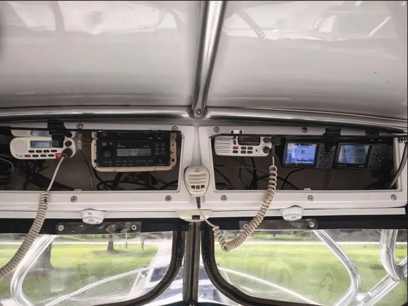 Slide: The Image of Dashboard of a 1990 Pursuit 2350 boat with communication equipment. - 7