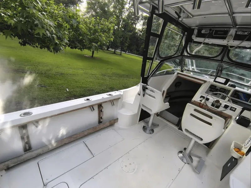 Slide: The Image of Interior view of a 1990 Pursuit 2350 boat with helm station. - 8