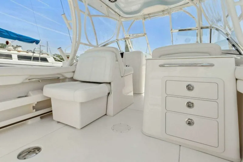Slide: The Image of Interior of 2022 Grady-White FREEDOM boat, white seating and cabinets. - 12