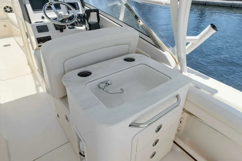 Slide: The Image of Grady-White FREEDOM 2022 boat cabin with sink and helm console. - 14