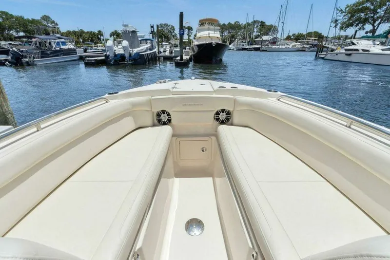 Slide: The Image of Grady-White FREEDOM 2022 boat in harbor, luxurious seating and speakers. - 23