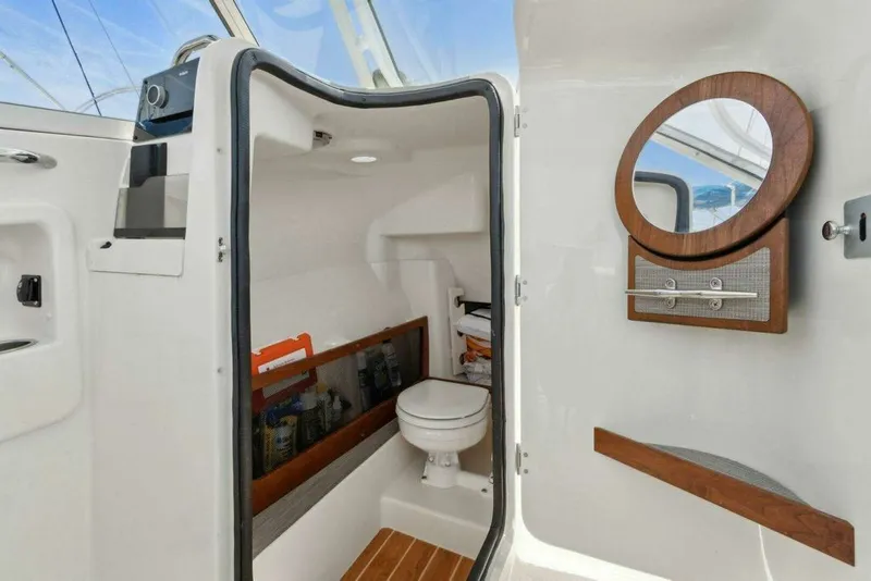 Slide: The Image of Interior of 2022 Grady-White FREEDOM boat with toilet and mirror. - 28