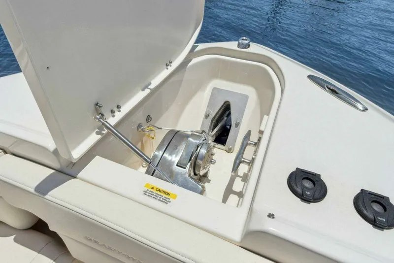 Slide: The Image of Grady-White FREEDOM 2022 boat anchor compartment with winch by water. - 33