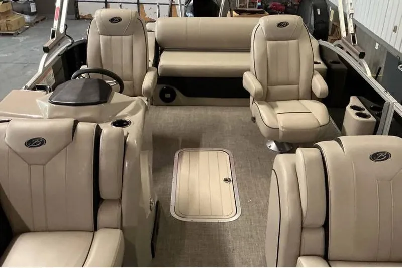 Slide: The Image of 2021 Barletta E24UC boat interior with beige seating and steering console. - 10