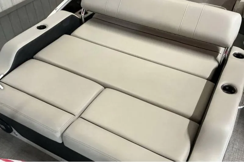 Slide: The Image of 2021 Barletta E24UC boat interior with beige cushioned seating and cup holders. - 12